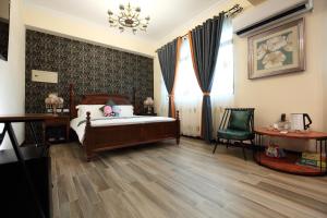 a bedroom with a bed and a desk and a chair at Min Le Yuan B&B-include long stay in Hualien City