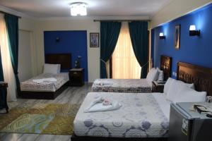 Postel nebo postele na pokoji v ubytování Amin Hotel