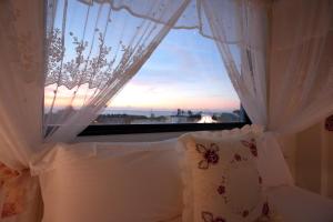 a bedroom with a window with a view of the ocean at Min Le Yuan B&B-include long stay in Hualien City