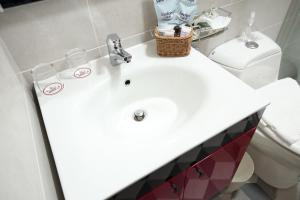a bathroom with a sink and a toilet at Min Le Yuan B&B-include long stay in Hualien City