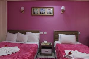 Postel nebo postele na pokoji v ubytování Amin Hotel
