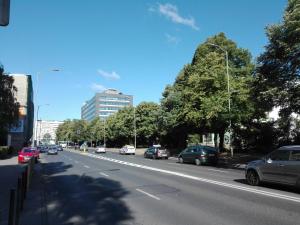 a busy city street with cars parked on the road at Mieszkanie Bez Barier in Szczecin