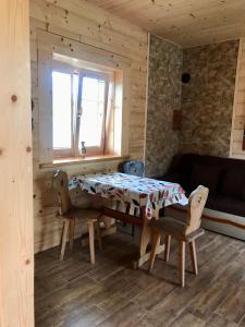 a dining room with a table and chairs and a window at Serce Beskidu Niskiego in Świątkowa Mała +11 photos
