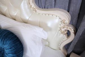a close up of a white chair with a blue pillow at Min Le Yuan B&B-include long stay in Hualien City