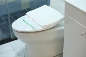 a toilet with a book sitting on top of it at Min Le Yuan B&B-include long stay in Hualien City