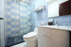 a bathroom with a toilet and a sink and a shower at Min Le Yuan B&B-include long stay in Hualien City