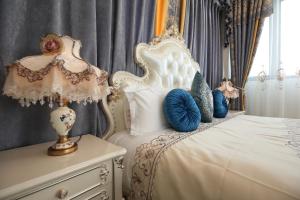 a bedroom with a white bed with blue pillows at Min Le Yuan B&B-include long stay in Hualien City