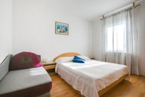 Apartments Gracijela tesisinde bir odada yatak veya yataklar