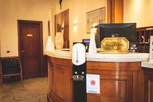 a pay station in a hotel room with a phone at Hotel Posta in Cecina