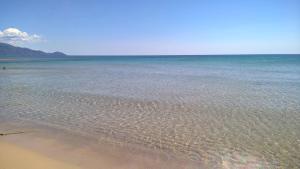 a beach with a body of water and the ocean at Arcamyrtus in Alghero