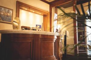 a bar in a restaurant with a large mirror at Hotel Posta in Cecina