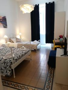 a bedroom with two beds and a living room at MiRhome Guest House in Rome