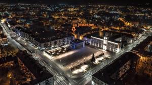 an aerial view of a city at night at Apartament ADA in Koszalin