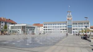 a fountain in the middle of a square with buildings at Apartament ADA in Koszalin