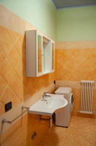 a bathroom with a sink and a toilet at Appartamenti Medusa in Alba Adriatica