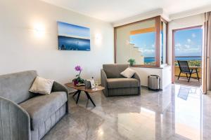 a living room with two couches and a table at Hotel Santa Chiara in Capo Vaticano