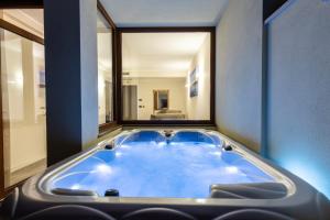 a bath tub in a room with a large window at Hotel Santa Chiara in Capo Vaticano