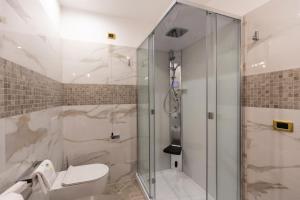 a bathroom with a shower and a toilet at Hotel Santa Chiara in Capo Vaticano