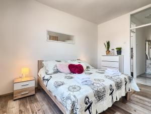 a bedroom with a bed with a black and white comforter at Apartment Joelle in Pula