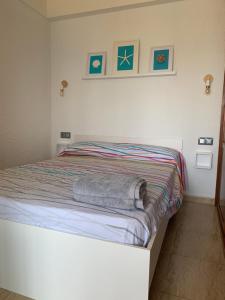 a bedroom with a bed with towels on it at Apartamento primera línea de Mar Enjoy the view in Blanes +16 photos