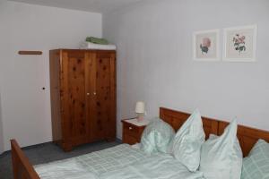 a bedroom with a bed and a wooden headboard at Haus Pirchl in Westendorf