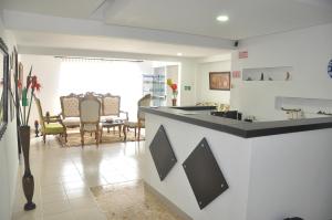 a kitchen with a counter and a dining room at Casa Hotel Manga Mar in Cartagena de Indias