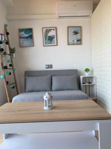 a bed in a small room with a table at Apartamento primera línea de Mar Enjoy the view in Blanes