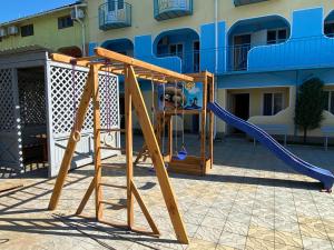 a playground with a slide in front of a building at Aquamarin in Zatoka