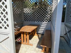 a wooden table and a bench on a patio at Aquamarin in Zatoka