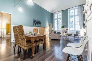 a living room with a wooden table and chairs at Family Apartments San Lorenzo in Genova