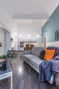a living room with a couch and a kitchen at Family Apartments San Lorenzo in Genova
