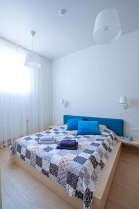 a bedroom with a bed with a quilt on it at Apartment near Baltic Sea in Jūrmala