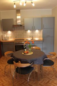a kitchen with a table and chairs in a kitchen at Ferienwohnung Sonneck in Bullay