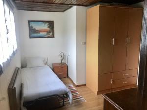 a small bedroom with a bed and a cabinet at Ferias Codeçoso in Codeçoso