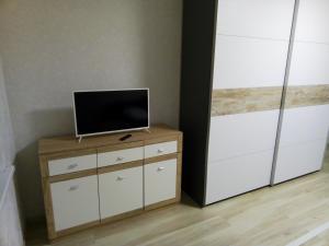 a room with a tv on a dresser with a cabinet at MEGACITY апартаменти на третьому поверсі in Kyiv
