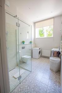 a bathroom with a glass shower and a toilet at Apartment near Baltic Sea in Jūrmala