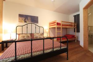 a bedroom with a bed and two bunk beds at Family Apartment HIRSCH in Bad Kleinkirchheim