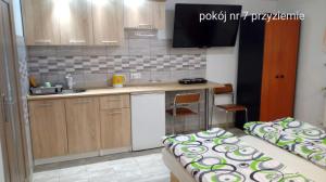 a small kitchen with a sink and a counter at Villa Vivaldi in Dziwnówek