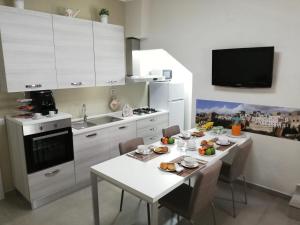 a kitchen with a table with food on it at Casa Vacanze Civico 32 in Montescaglioso