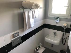 a bathroom with black and white tiles and a sink at Locanda Penaceto in Longare