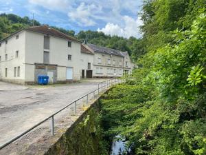 a row of buildings on a road next to a river at Burer Millen, Born Mühle in Born