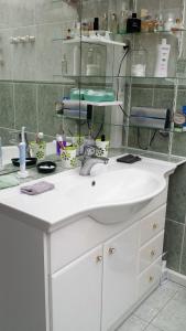 a bathroom with a white sink and a mirror at CHAMBRE PRIVEE AVEC SALON, garage voiture, vélos, motos in Tourville-sur-Arques
