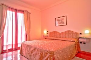 Postel nebo postele na pokoji v ubytování Hotel Santa Caterina