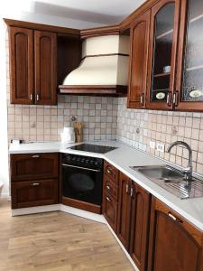 a kitchen with wooden cabinets and a sink at Apartment Mario in Piran