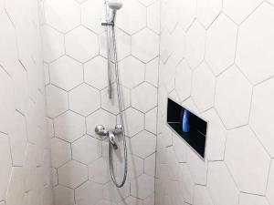 a shower with a shower head in a bathroom at Apartment Mario in Piran +8 photos