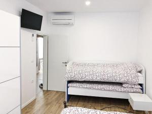 a white room with two beds in it at Apartment Mario in Piran