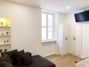 a living room with a couch and a tv at Apartment Mario in Piran