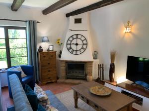 a living room with a large clock on the wall at Quinta Falzina in Luz