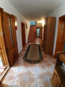a hallway with a floor mat in the middle of a room at Pensiunea Covaciu in Vadu Izei