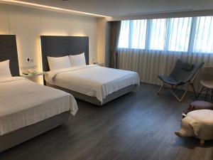 Postel nebo postele na pokoji v ubytování Golden Garden Hotel